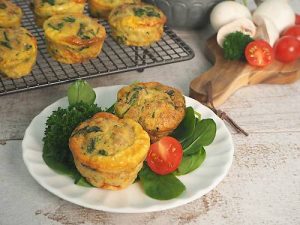 Egg and Meat muffins on white plate with salad