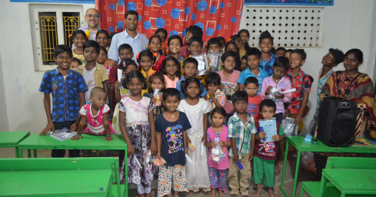 Children holding up their gifts at the good news centre