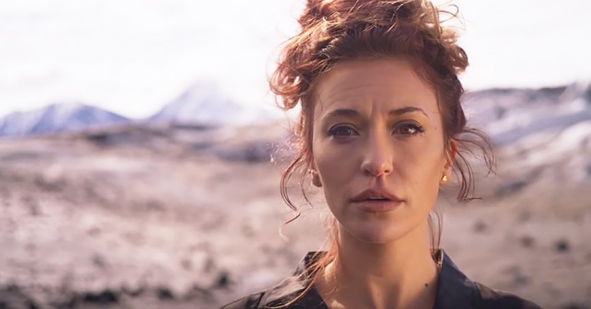 Lauren Daigle with desert background looking directly at camera