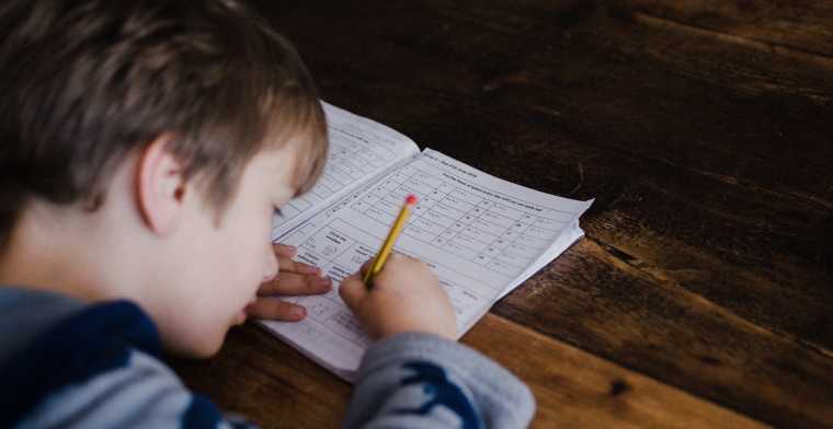photo of a boy doing his homework