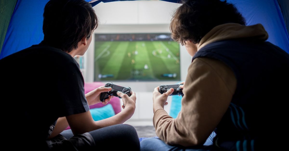photo of two boys playing an x box
