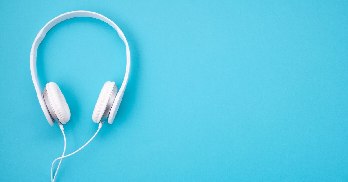 photo of white headphones on light blue background