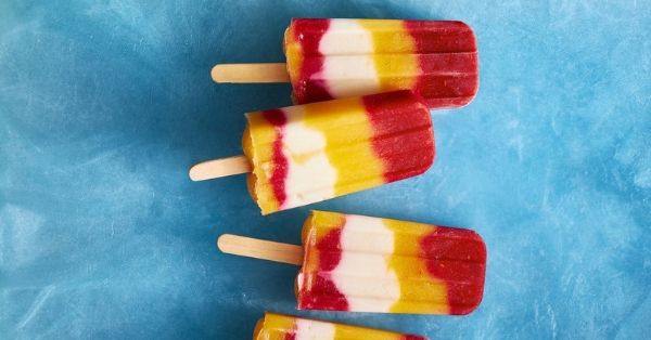 photo shows red and yellow coloured ice blocks on sticks