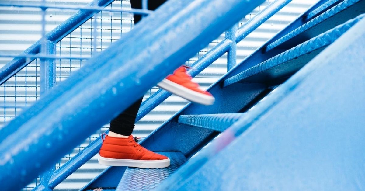 red shoes going up blue stairs