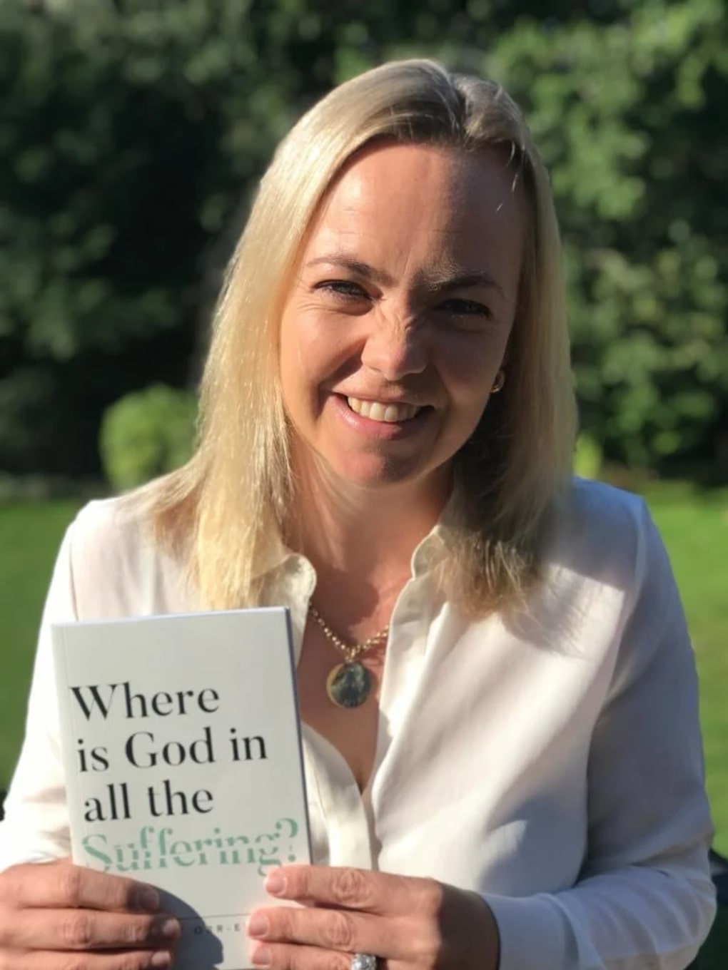 dr amy orr-ewing holds a copy of the book where is god in all the suffering?
