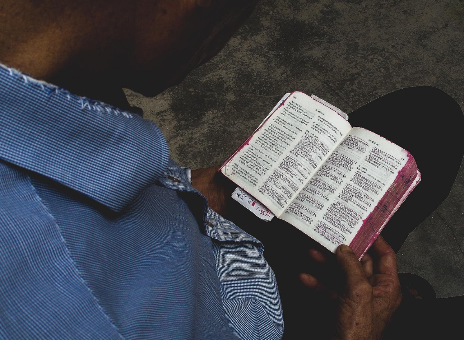 man reading a chinese bible