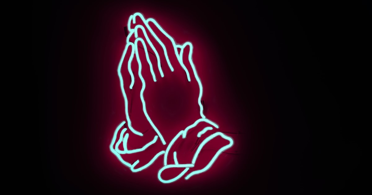 neon sign hands held in prayer