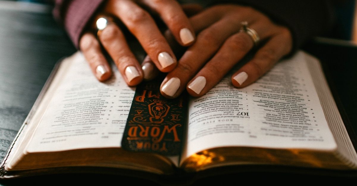 Woman praying and reading Bible