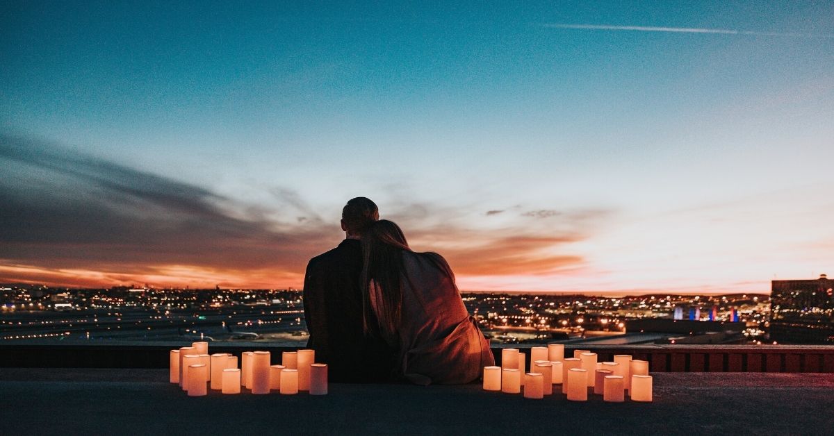 Couple watching sunset over city