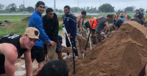 Local residents and members of the Cowboys NRL team helped on Saturday with sandbagging and building levy walls.