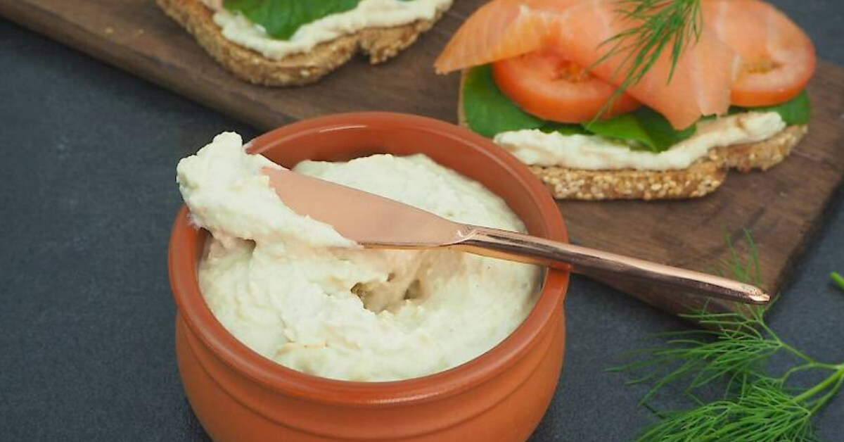 nut cheese spread in a pot beside crackers