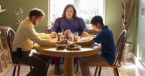 Scene from the movie Breakthrough with Father, Mother and Son holding hand in prayer around a table before a meal