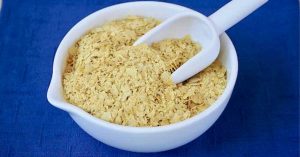 Nutritional yeast flakes in white bowl