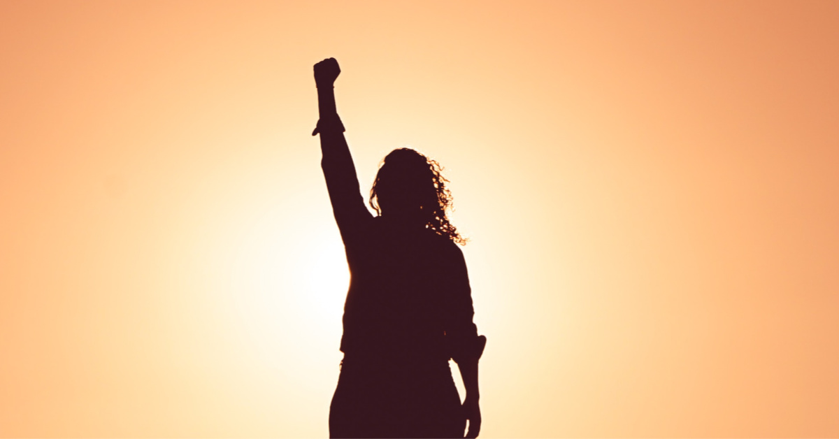 woman raising fist into air