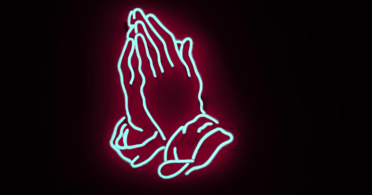 neon lights of hands together in prayer