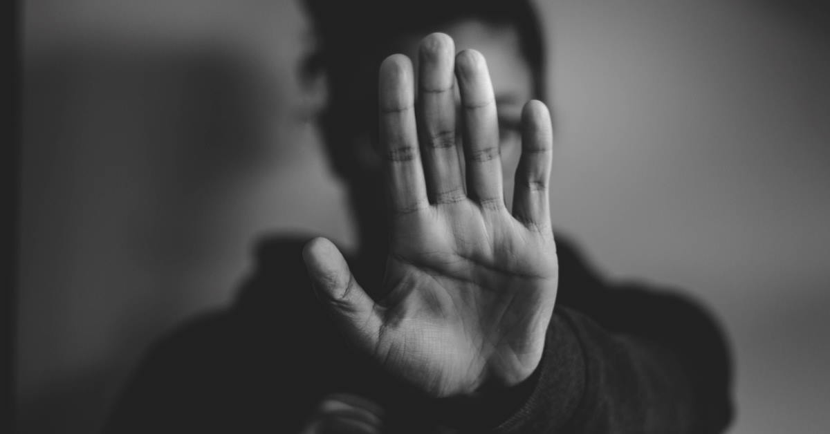 close-up black and white photo of person lifting hands