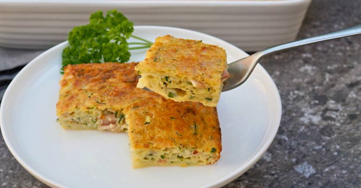 squares of zucchini slice on a plate with one picked up by a fork