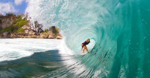 bethany hamilton riding a surfboard inside the curve of a wave