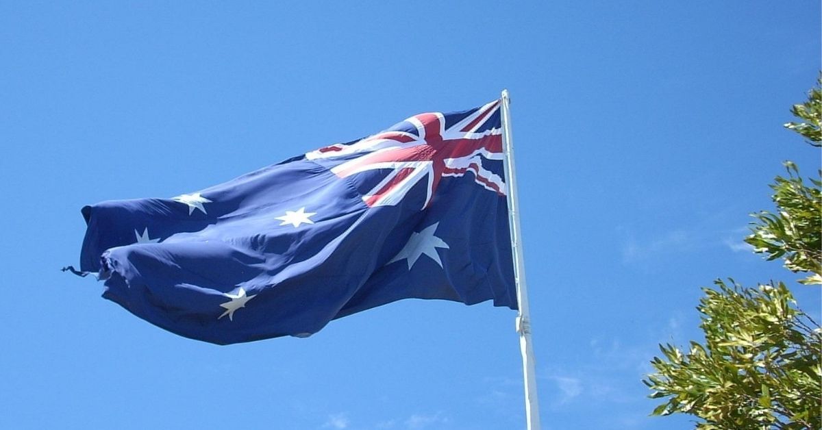 an australian flag flying slightly fraying on the ends