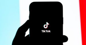 tiktok app logo on phone silhouette