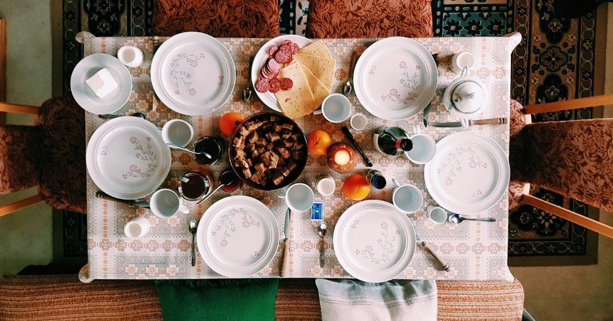 a dining table with plates laid out