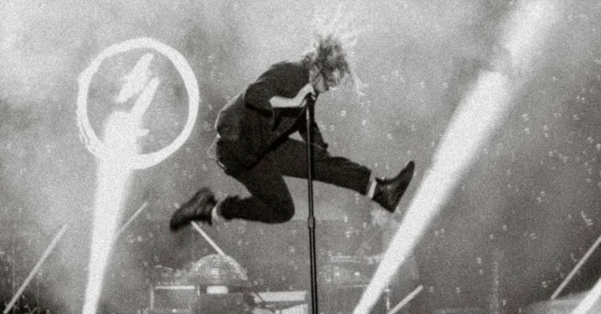 black and white shot of switchfoot vocalist jumping