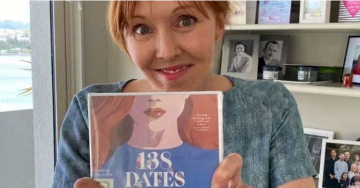 rebekah campbell holds a copy of her book 138 dates