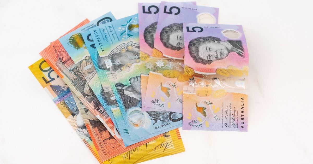australian notes splayed out on a white table