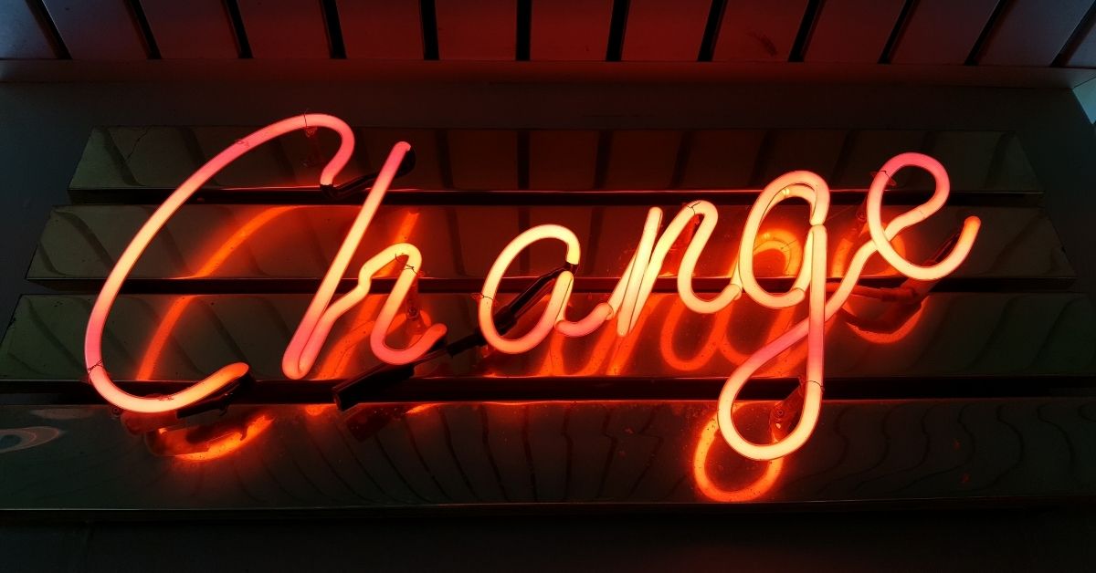 big orange neon sign which reads "change"