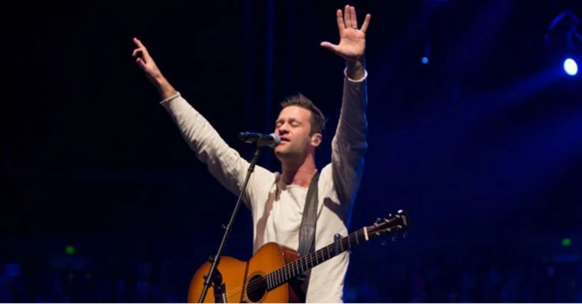 ben fielding with arms raised and eyes closed in worship
