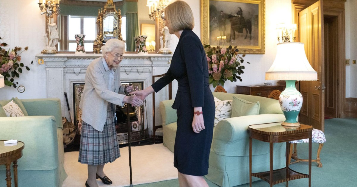 Queen Elizabeth reaching out to shake hands with new Prime Minister