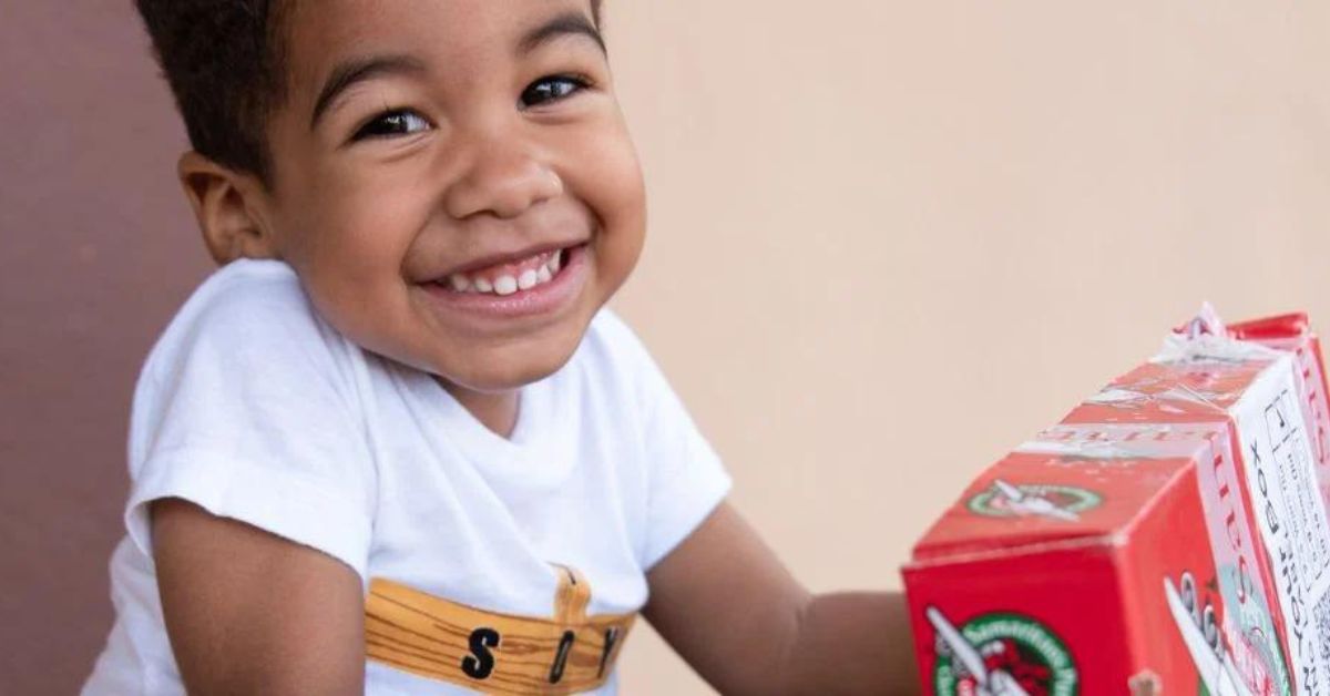 Child receiving a Christmas Shoebox