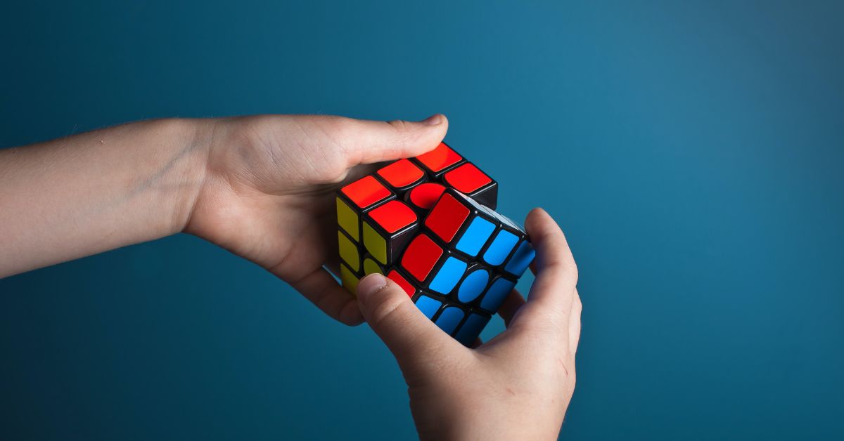 Child solving a Rubiks cube