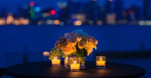 Candlelit dinner setting with city lights in the background