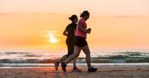Two women running on beach