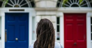 Woman choosing between blue and red doors