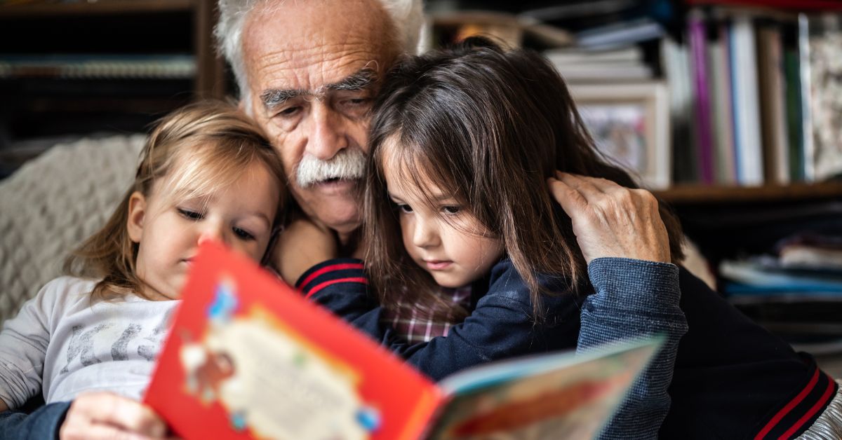 Grandpa reading with grandchildren