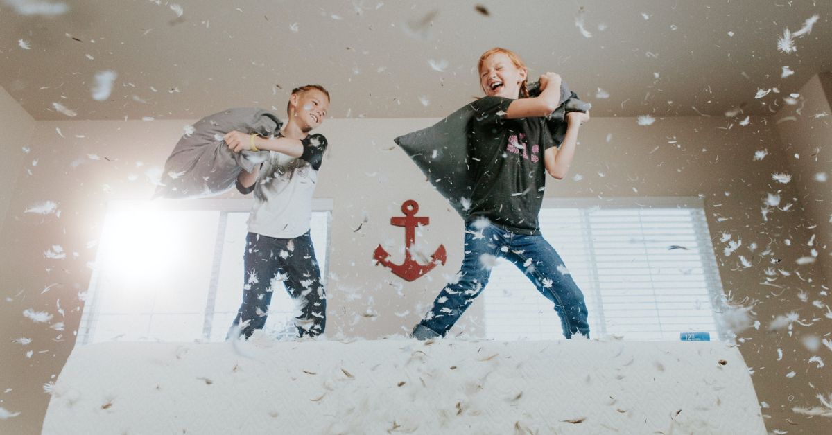 Kids playing pillow fights