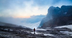 Man in wilderness cloudy sky