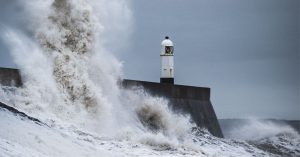 Stormy seas and lighthouse by Marcus Woodbridge, Unsplash