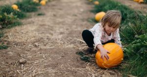 Child and pumpkin