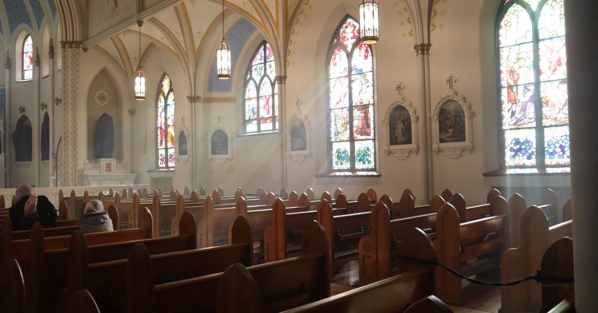 Pews and stained glass windows in in an old church