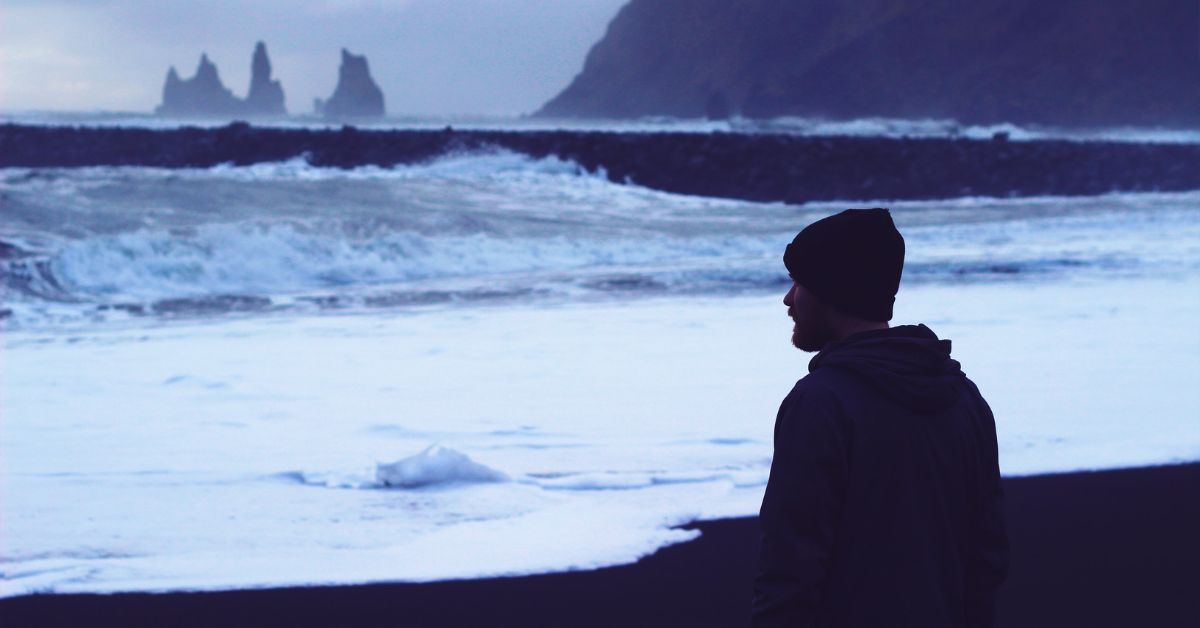 Man at beach looking at horizon