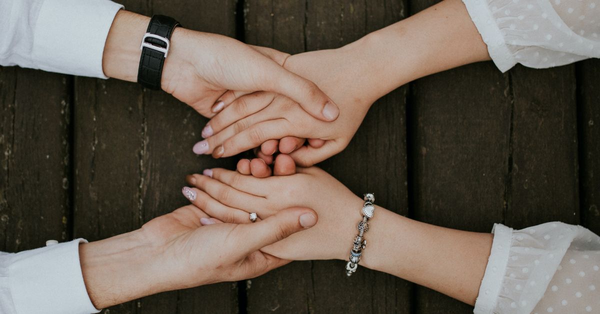 two friends holding hands