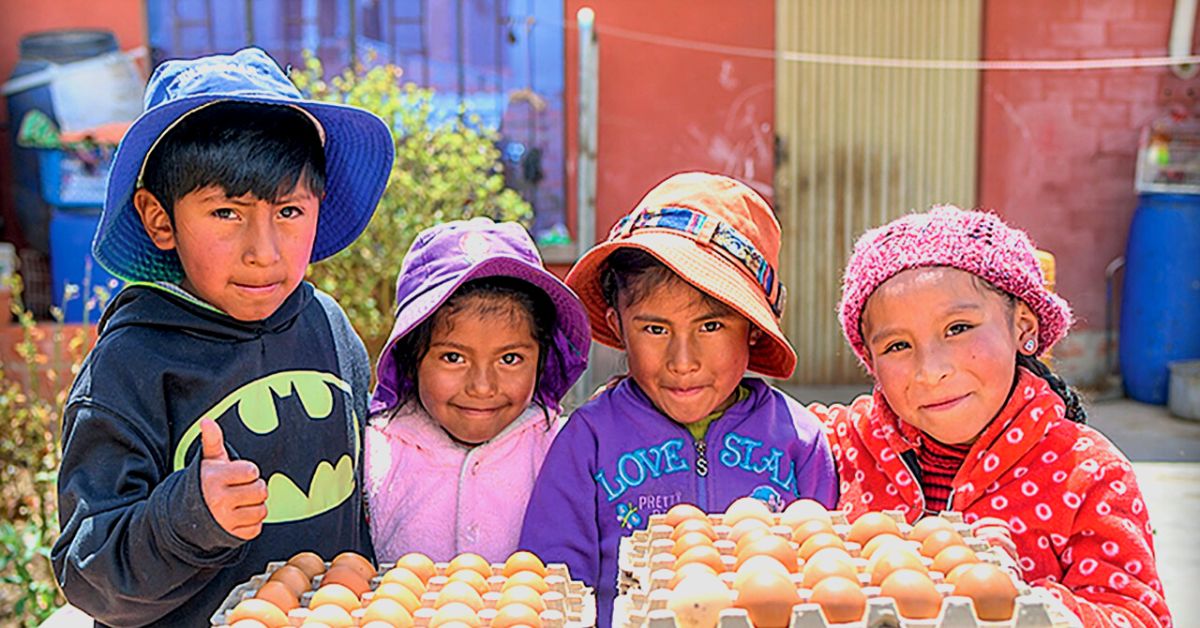 Children with eggs laid by their own chickens as part of SP Development programs