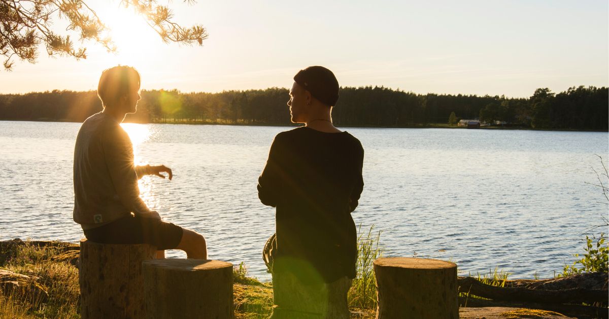 Two young men outdoors talking