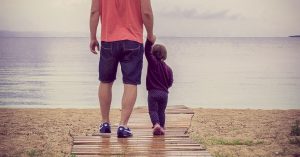 Father and daughter walking at beach