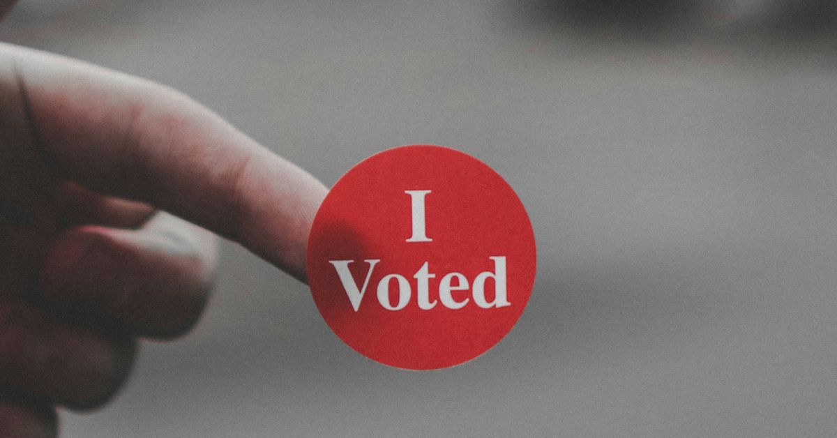 Person holding an 'I Voted' sticker
