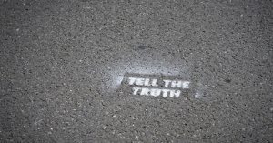 Sign on pavement - Tell the Truth