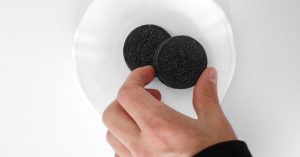 A hand reaching for Oreo cookies
